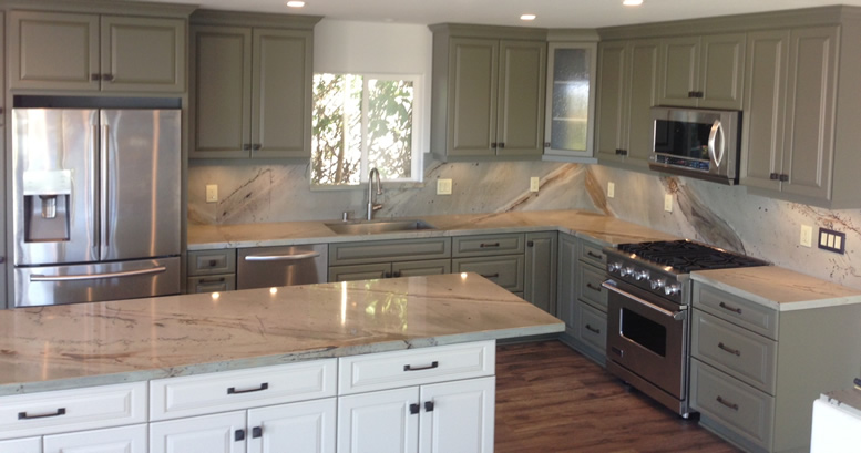 Granite countertops in a kitchen with painted cabinets